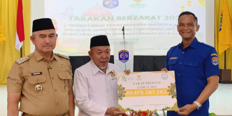 Direktur Perumda Tirta Alam Tarakan, Iwan Setiawan menyerahkan zakat profesi kepada Ketua Baznas Tarakan, K.H, Zainuddin Dalila
